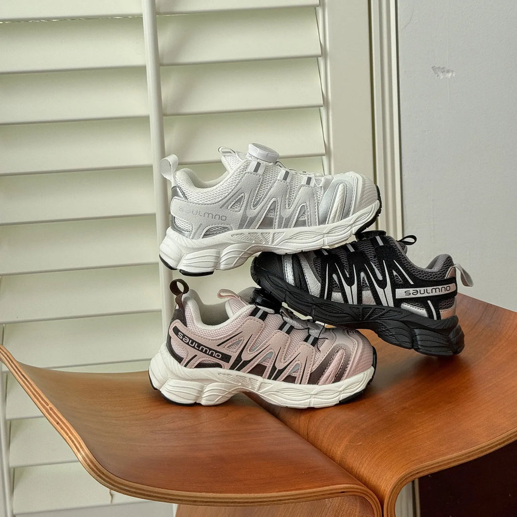 Girls lightweight casual sneaker in PU leather mesh, shown in solid black, beige, or pink.