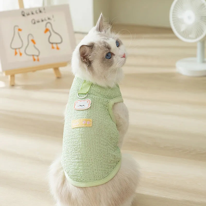 Cat wearing blue knitted clothing with bear patch and hollowed-out breathable design