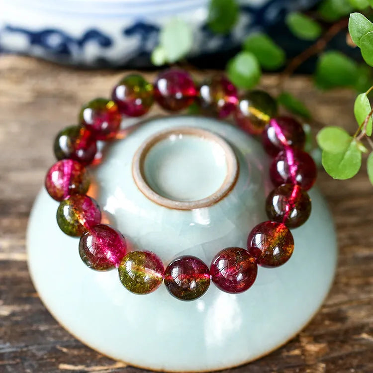 Handmade women's bracelet with red and green watermelon crystal beads on a string.