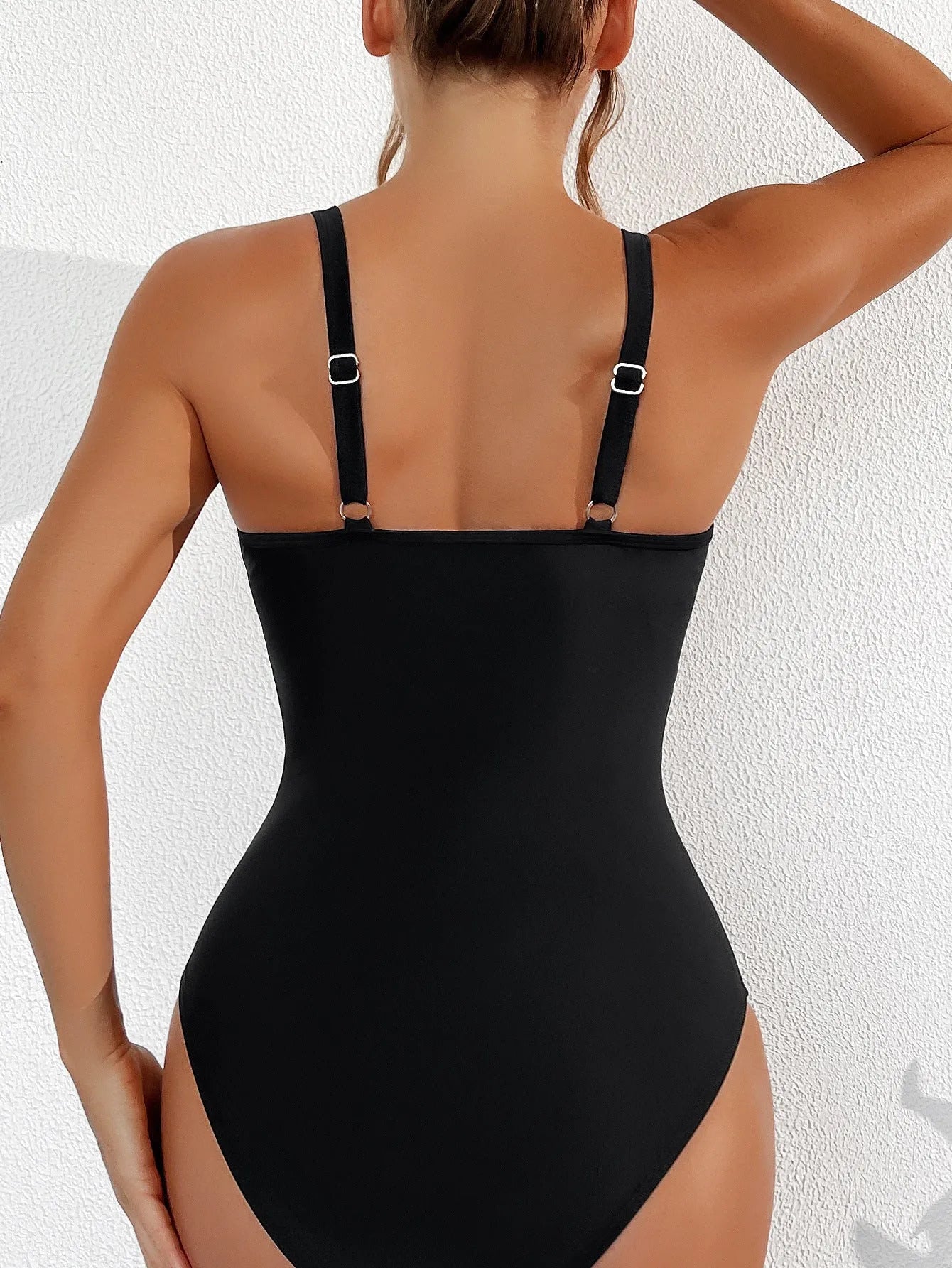 Black mesh halter bikini one-piece swimsuit on model showing sleeveless design and briefs style