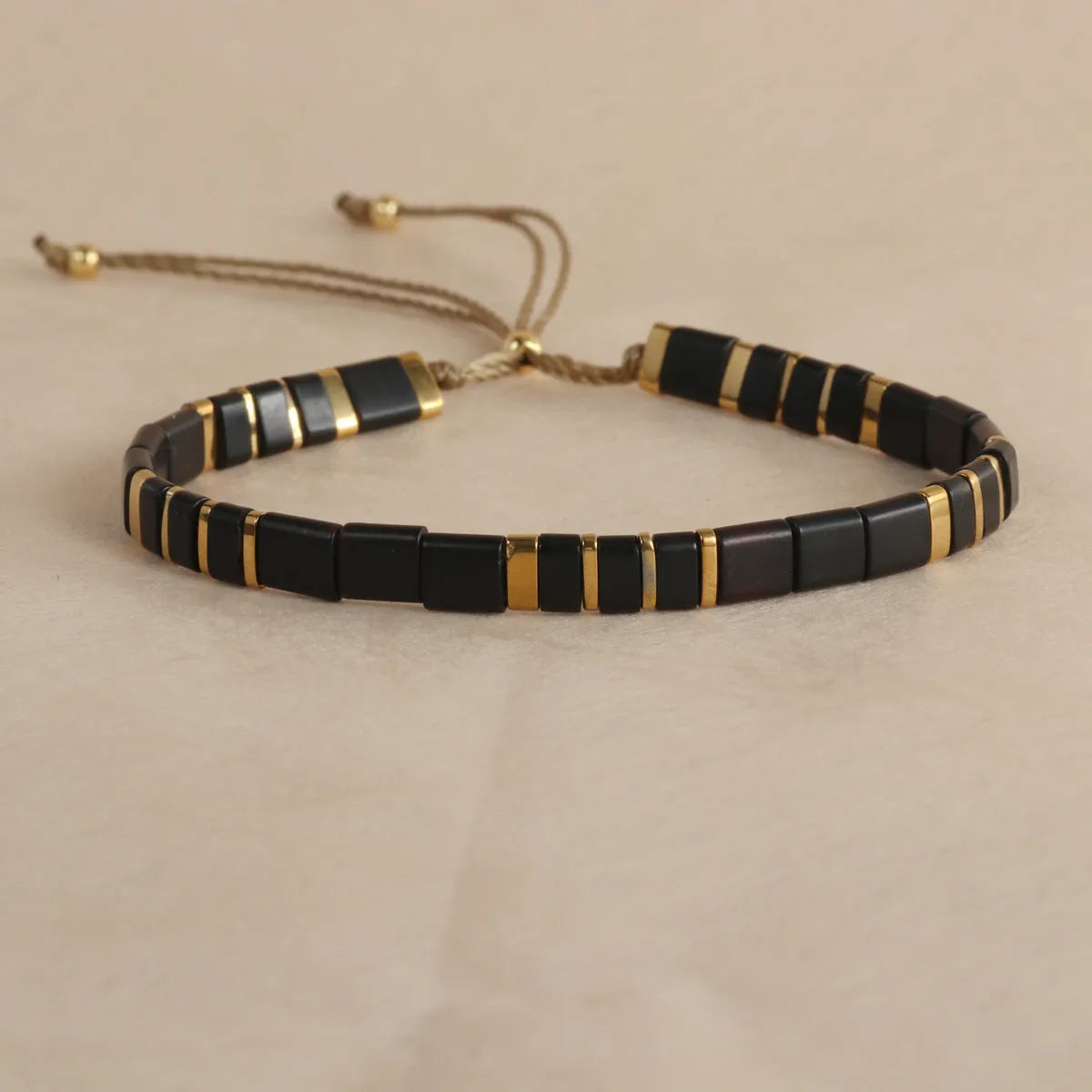 Adjustable glass beaded bracelet in geometric design with round beads available in five colours