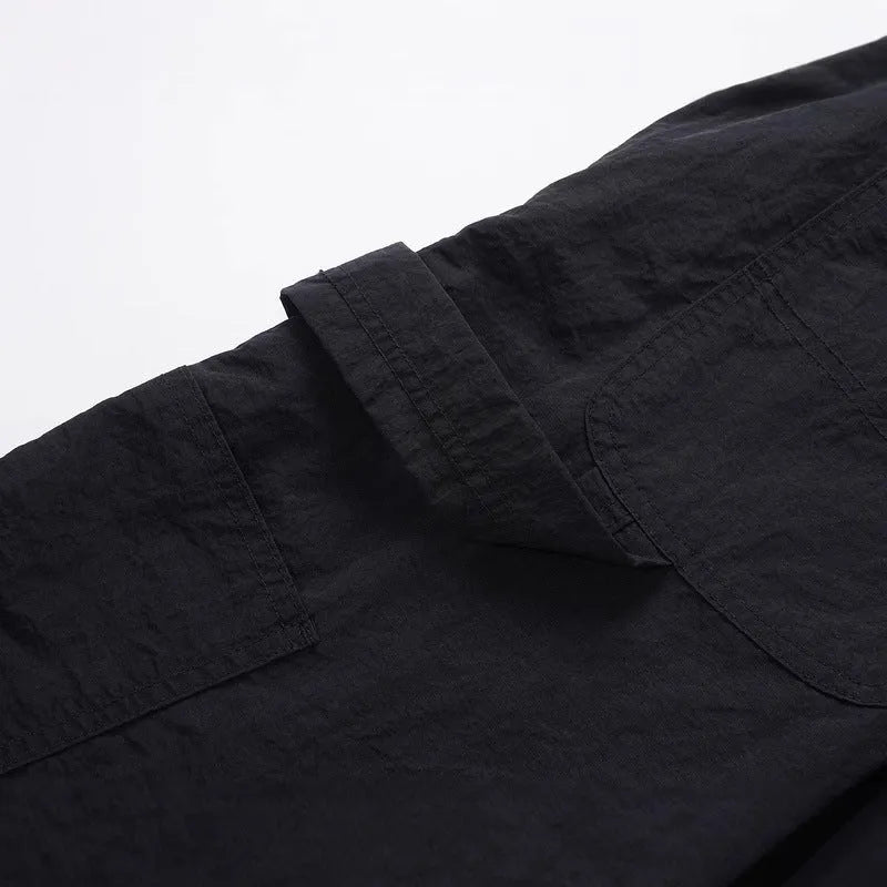 Black baggy paratrooper pants with an elastic drawstring waistband on a mannequin.