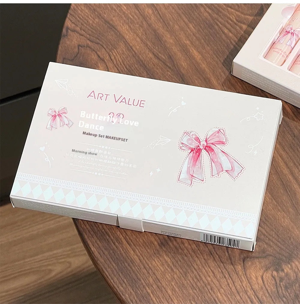 Butterfly Box makeup set showing four pink lip muds, a powder blusher, and a necklace