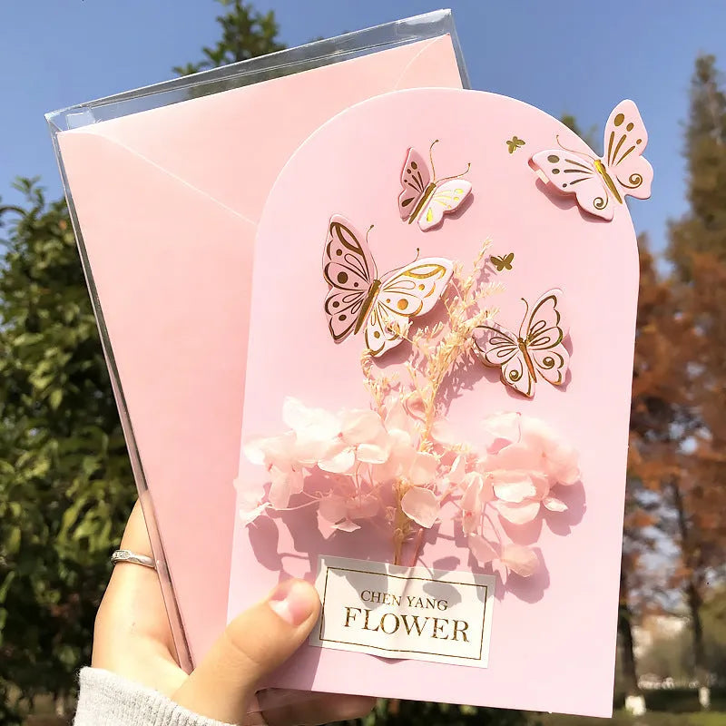 Handmade 3D butterfly-shaped birthday card with artificial flowers and hot foil stamping details.