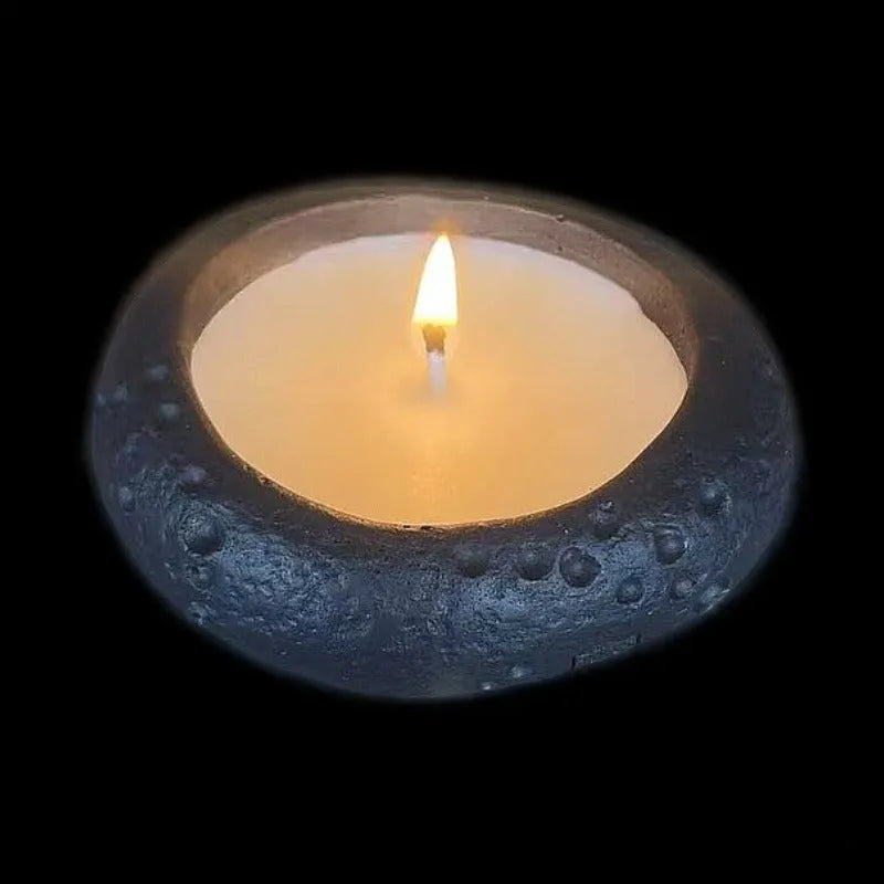 Fair-faced concrete candlestick ornament in white colour on a flat surface