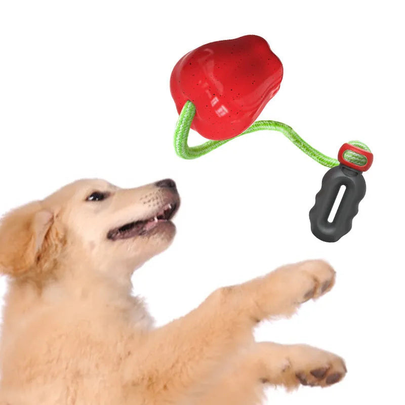 Green Apple-shaped dog toy with dropping ball mechanism for food reward chewing activity