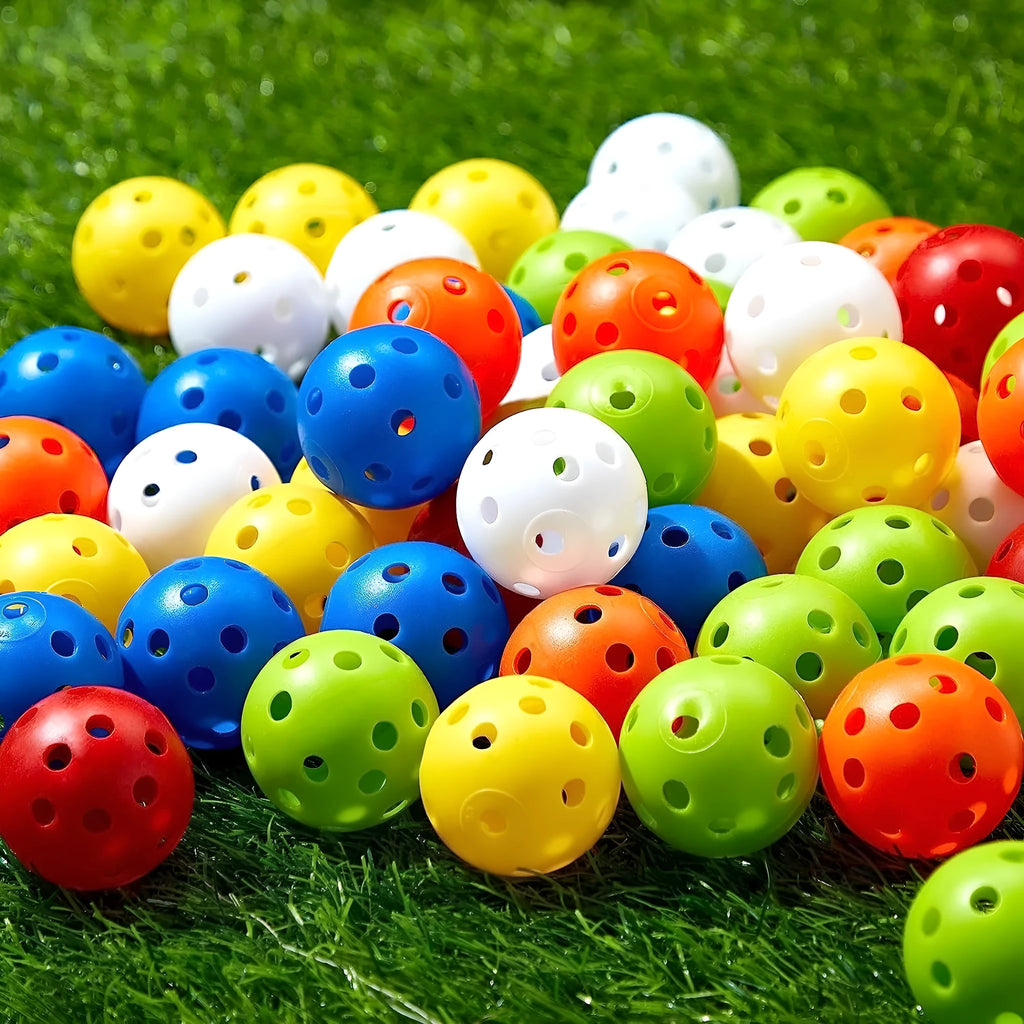 Multi-colour golf practice balls with 26-hole design including red, orange, blue, green, white and yellow