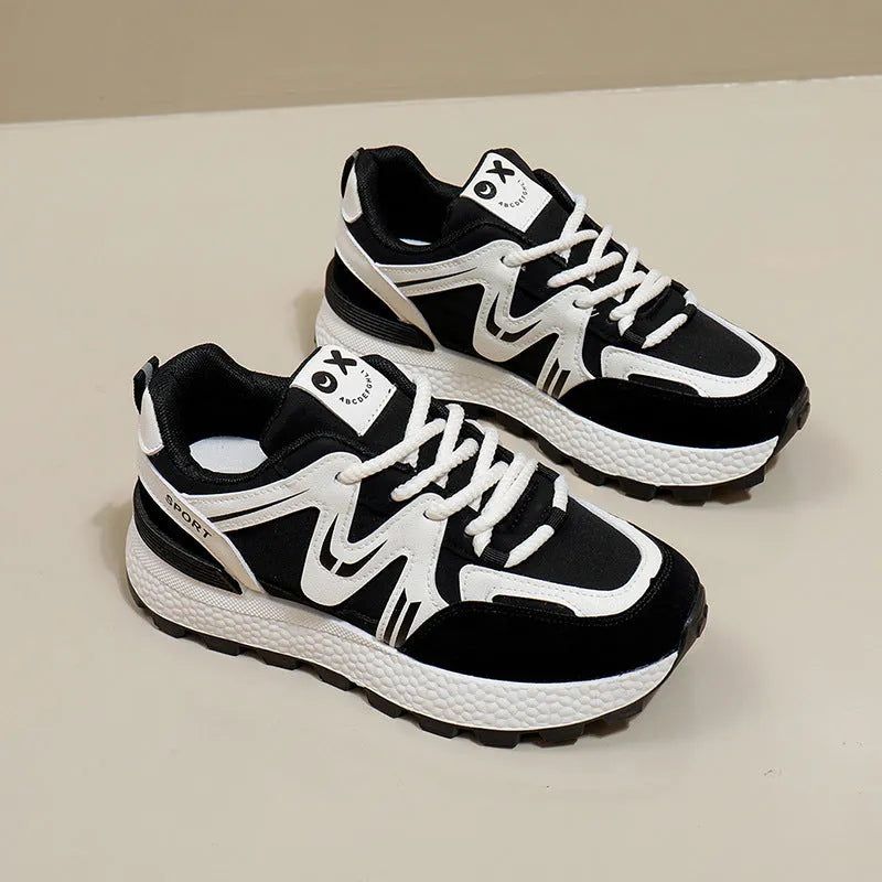 Women's black casual flat shoes with round toe and front lace-up design on a plain background.