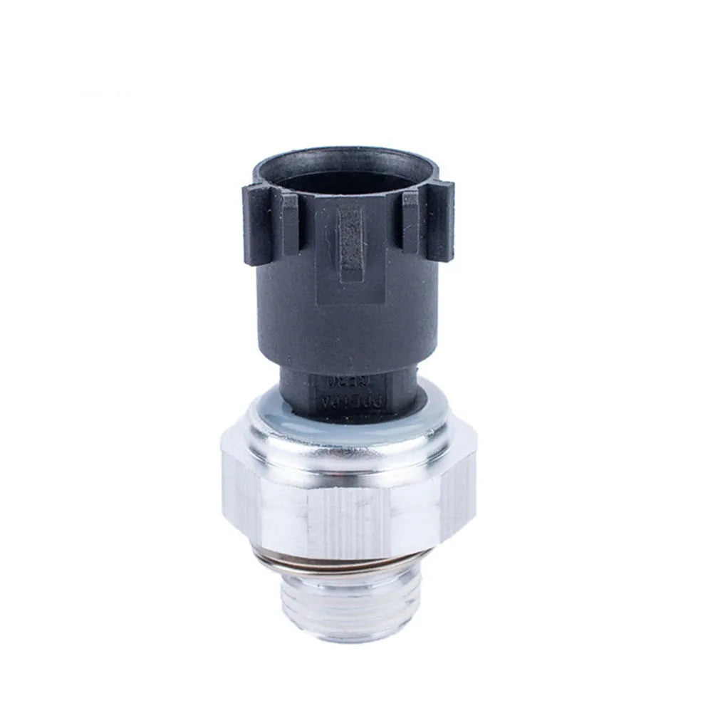 Silver metal automobile fuel pressure sensor on a plain background