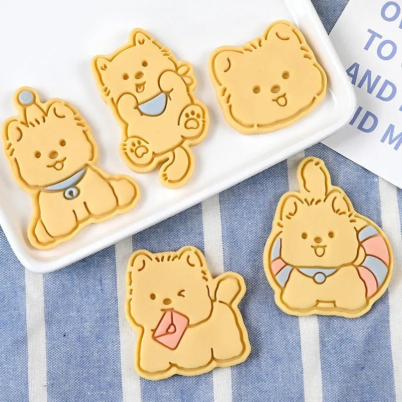 Plastic 3D cartoon puppy biscuit mould showing seven style variations including birthday hat and swimming ring designs