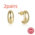 A single glossy C-shaped sterling silver stud earring on a plain background, showing gold and silver finish options.
