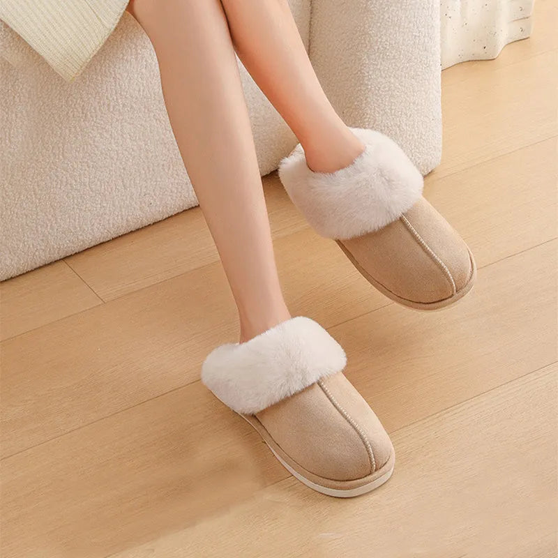 A pair of round-toe flat-heel plush slippers with stitching detail, shown in one of five available colours.