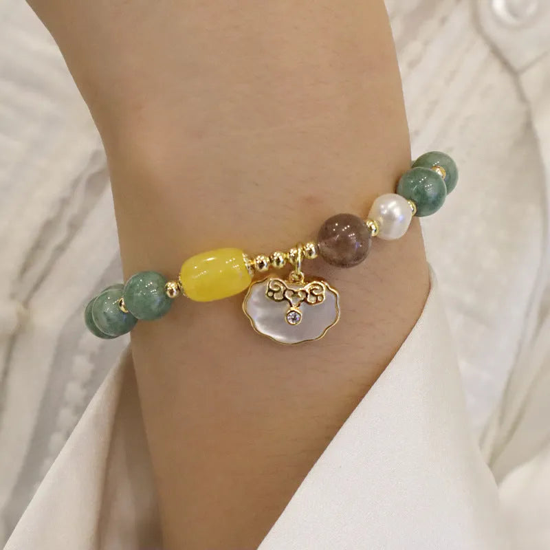 Women's fashion bracelet made from natural green jade shells on a casual background