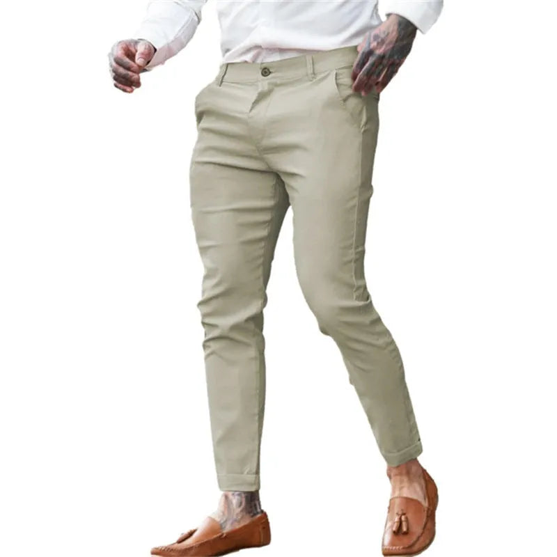 Men's slim-fit pencil trousers in high elasticity cotton twill fabric on a grey background.