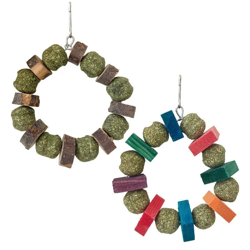 Hamster chew toy with Applewood stick and woven straw ball ring on a white background.