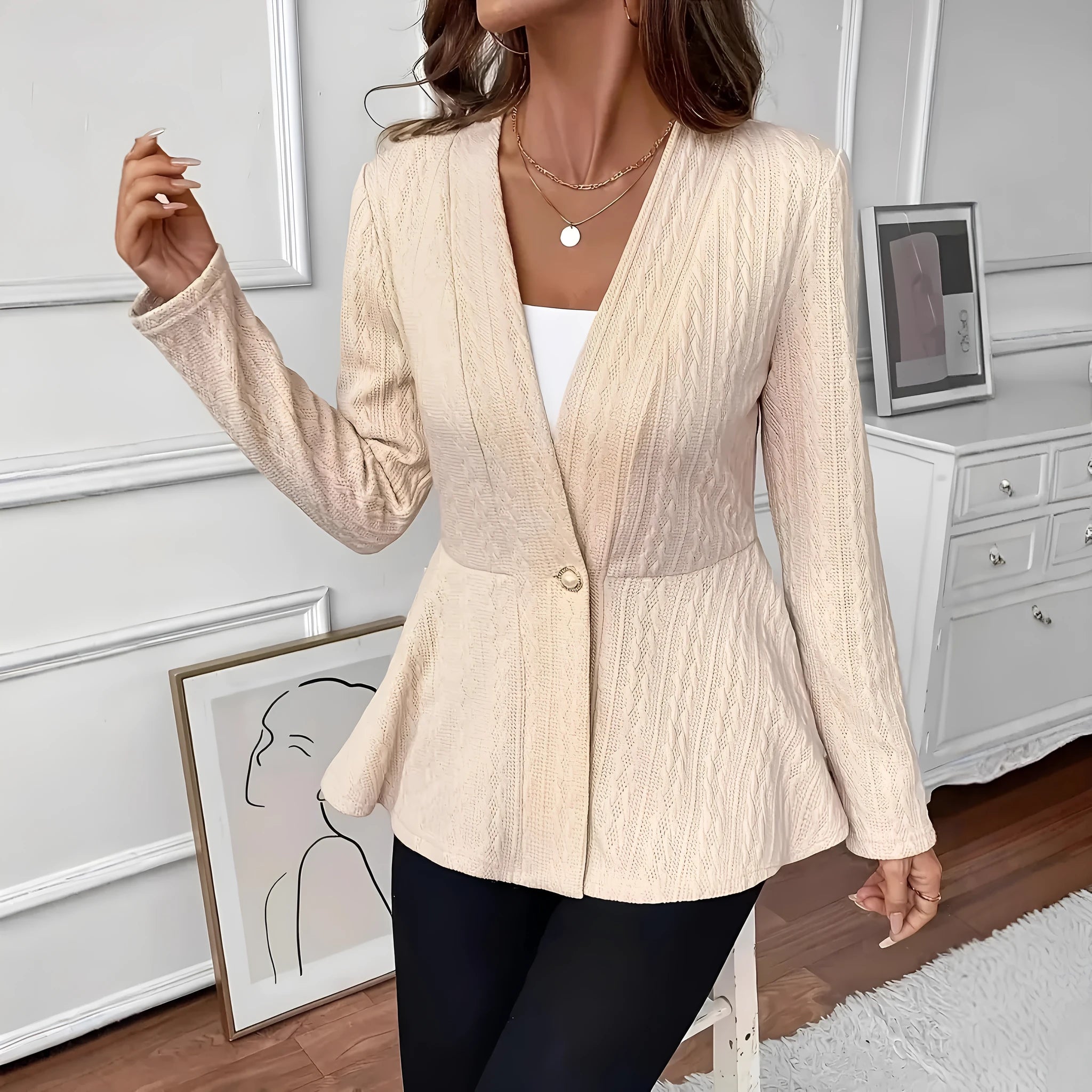 Women's apricot jacquard knit cardigan with one button, shown on a model.