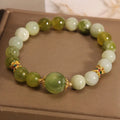 Original design women's bracelet with a single green Xiuyan jade stone in a Mori style.