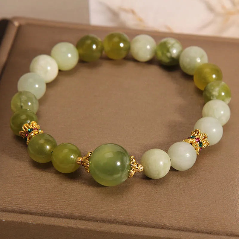 Original design women's bracelet with a single green Xiuyan jade stone in a Mori style.