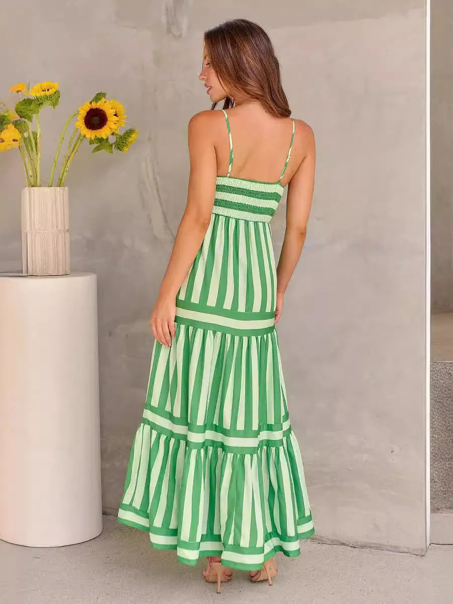 Women's striped backless summer dress with suspender straps and side pockets in a blue colour.