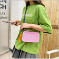 Transparent square jelly shoulder bag with adjustable strap showing internal mobile phone compartment