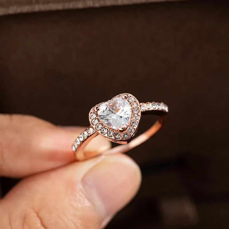 Heart-shaped women's fashion ring with crystal details in rose gold or silvery electroplated finish.