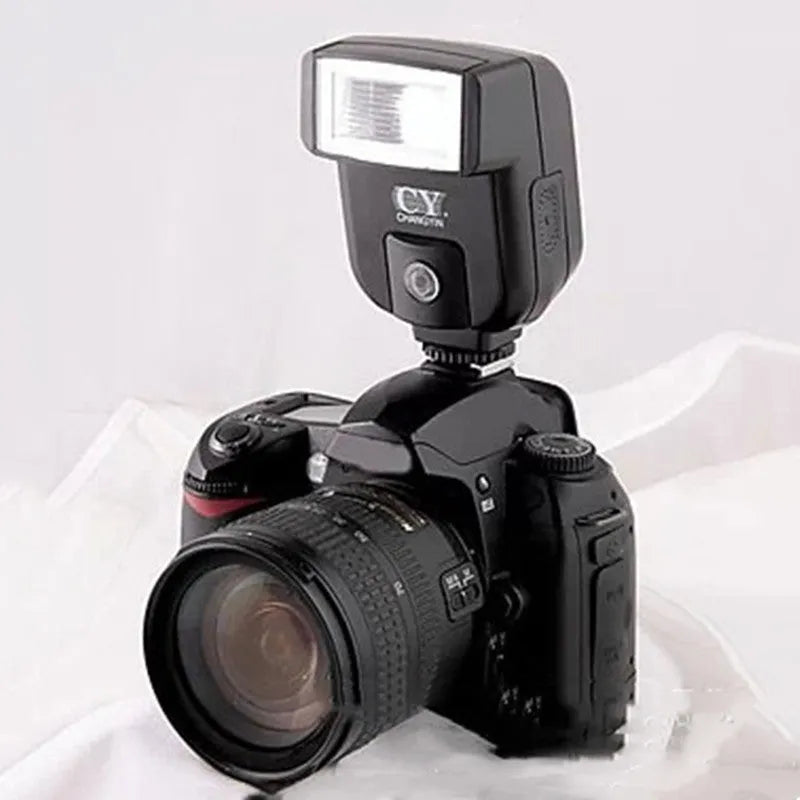 Silver hot shoe flash unit tilted on SLR camera showing aluminium construction and compact 65x60x98mm dimensions