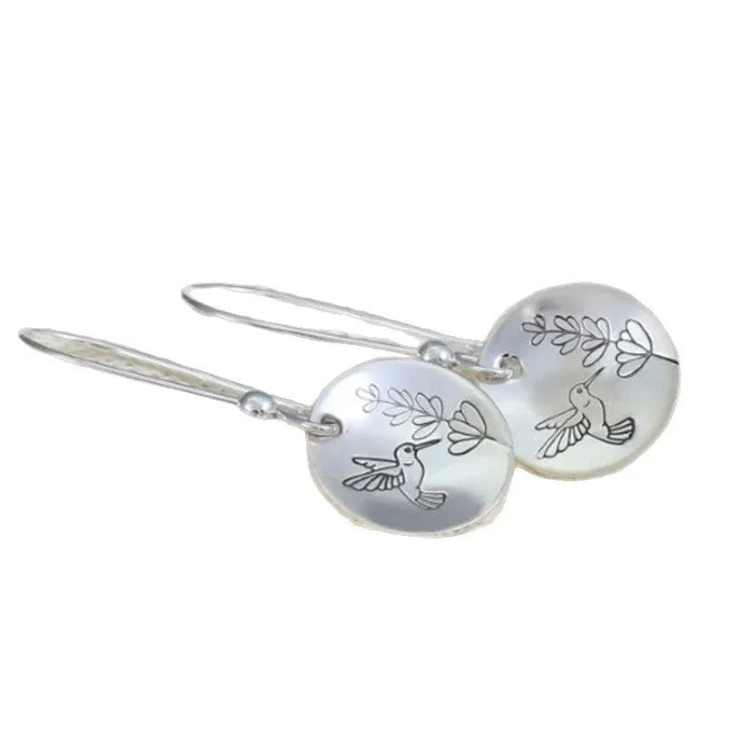 Silver glossy round women's earrings with bird and leaf motif