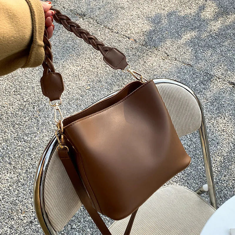 Retro-inspired woven PU crossbody bucket bag in khaki colour showing androgynous design details