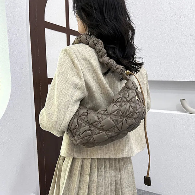 Beige nylon women's casual shoulder messenger bag with a long strap, shown from the side.
