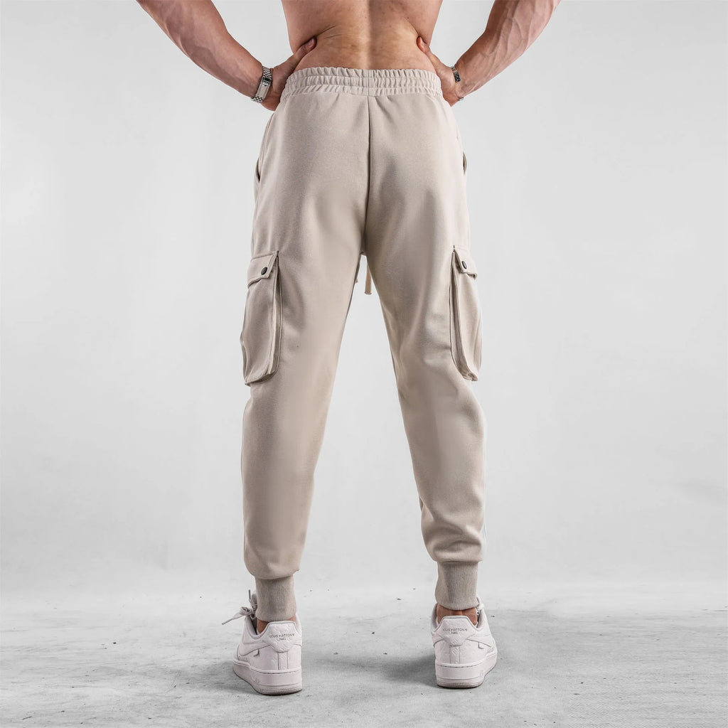 Men's loose cotton sports trousers with ankle-tied cuffs in solid colours