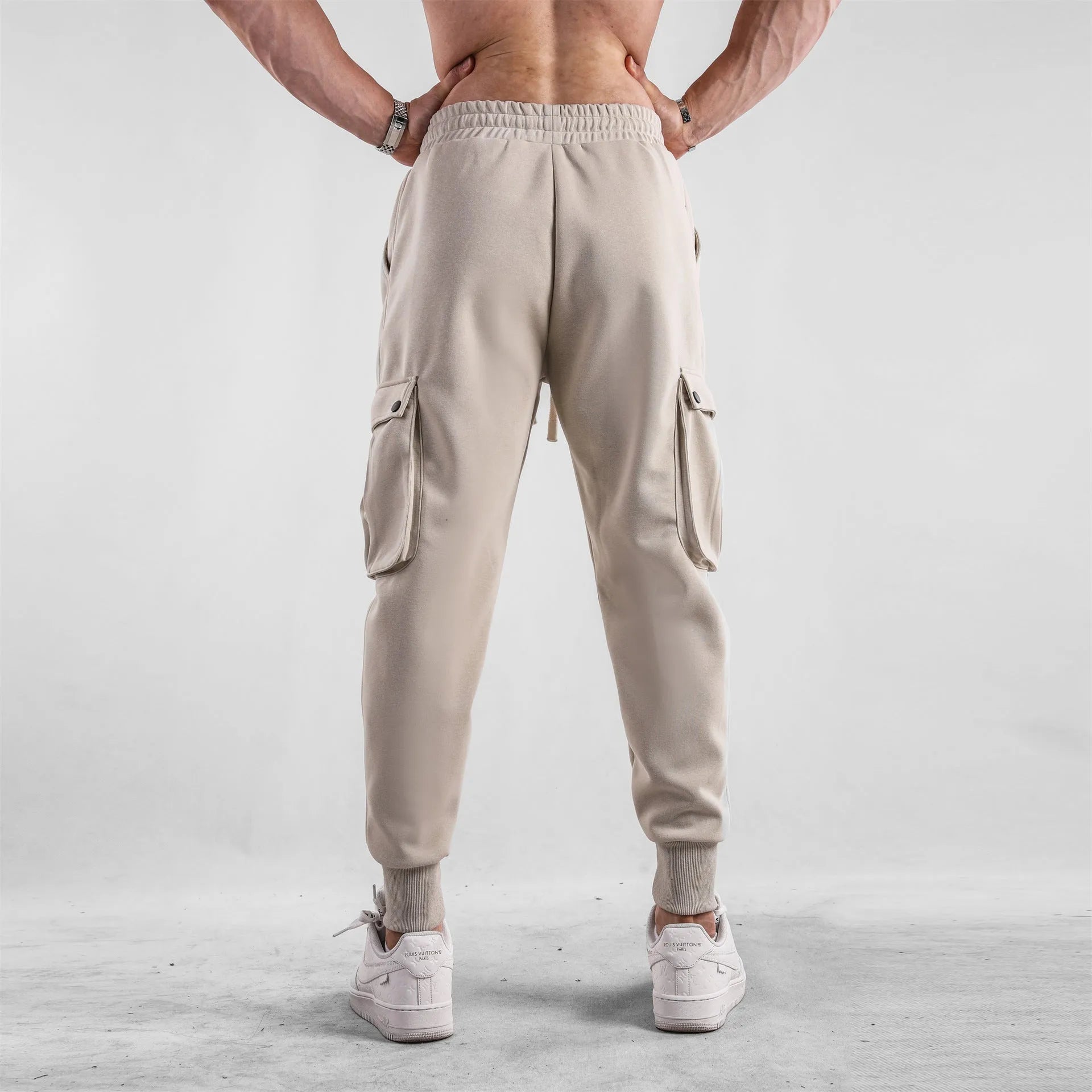 Men's loose cotton sports trousers with ankle-tied cuffs in solid colours