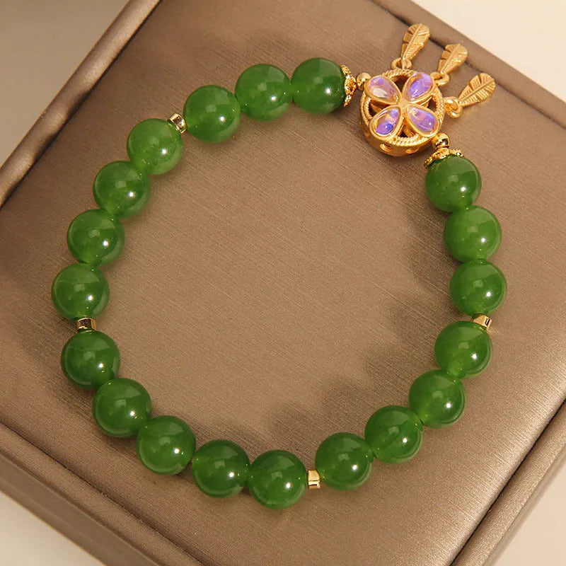 Green Jasper Crystal four-leaf clover dreamcatcher pendant on a women's bracelet.