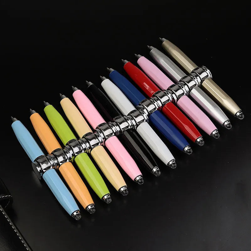 Metal LED spinning gyro ballpoint pen in hand, showing fidget spinner top and pen tip.