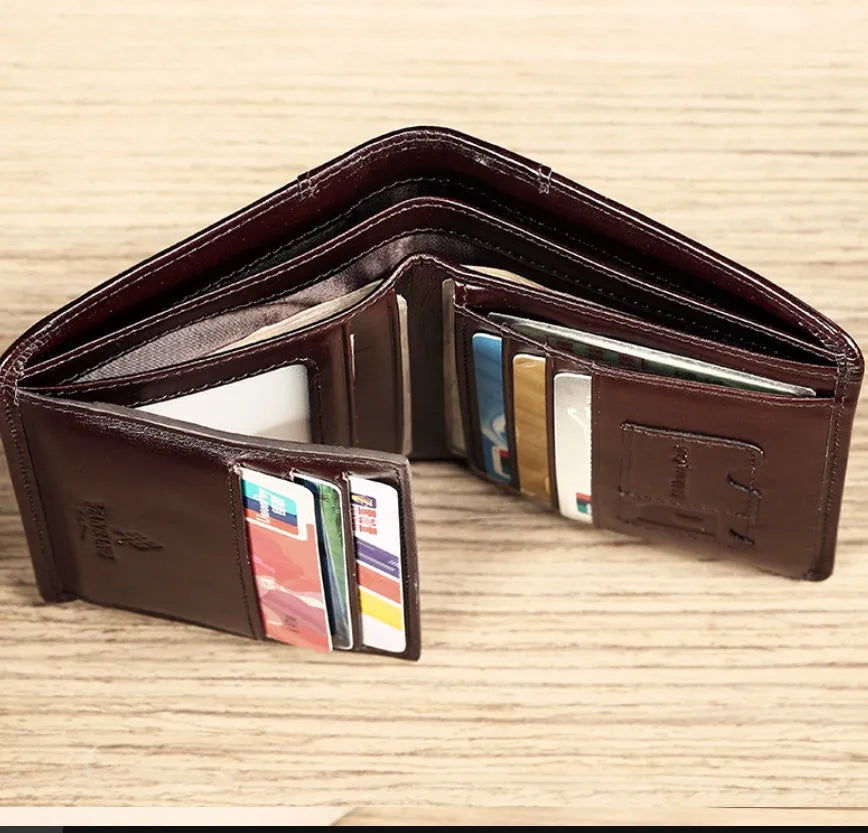 Men's leather wallet open to show internal card slots, cash section, coin pocket, and document holder.