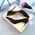 Women's silver and black stiletto wedding shoes with crystal details on a heel.