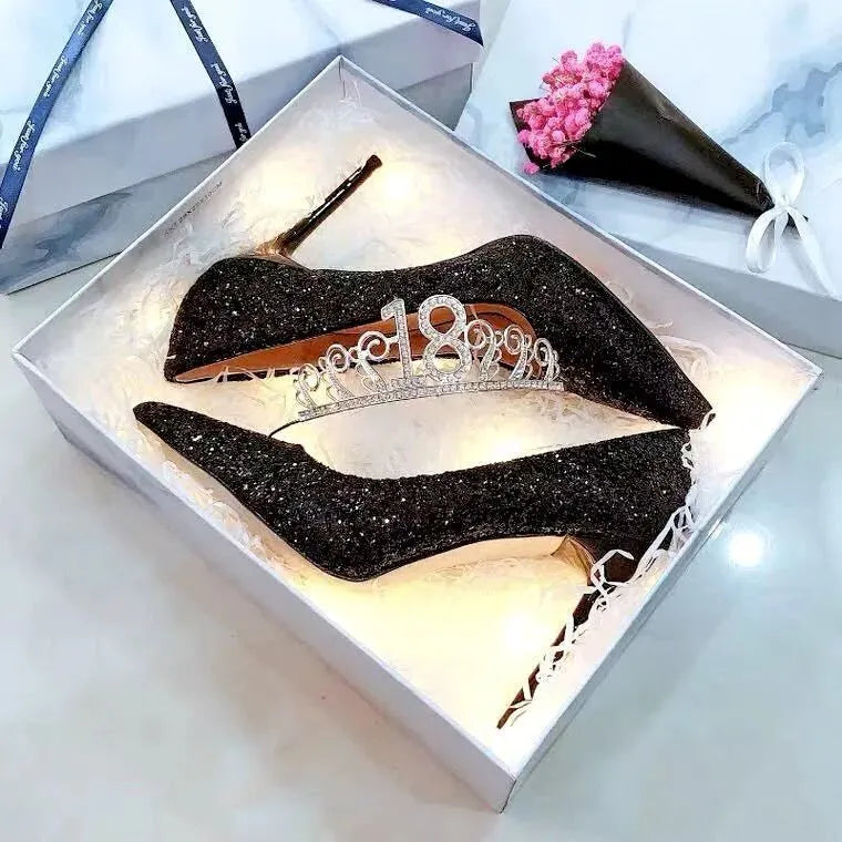 Women's silver and black stiletto wedding shoes with crystal details on a heel.