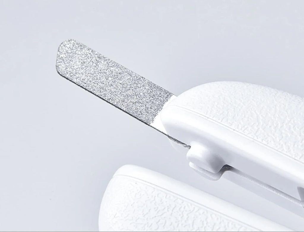 White pet nail clippers with LED light and transparent splash guard open, showing the triangular steel blade.