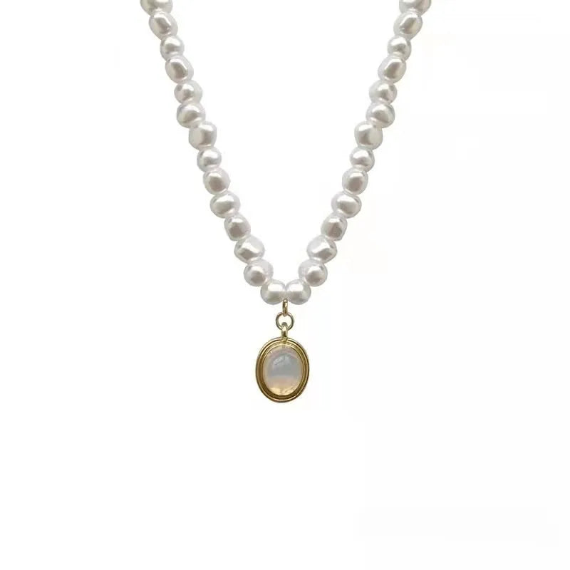 Adjustable French court vintage style pearl necklace with geometric design on a model.
