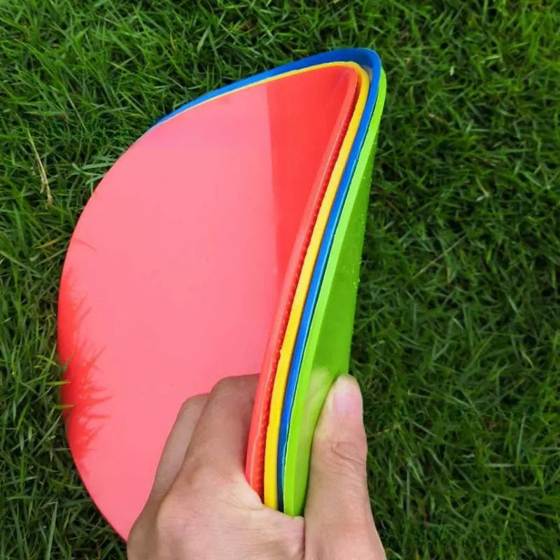 Soft yellow TPE football training disc on grass, showing 23cm diameter flat marker.