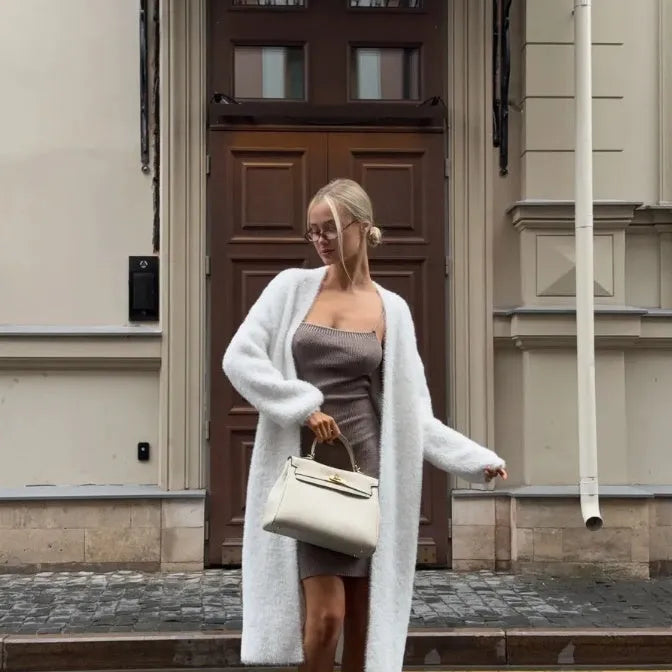 White women's knitted cardigan jacket with extended length and loose fit