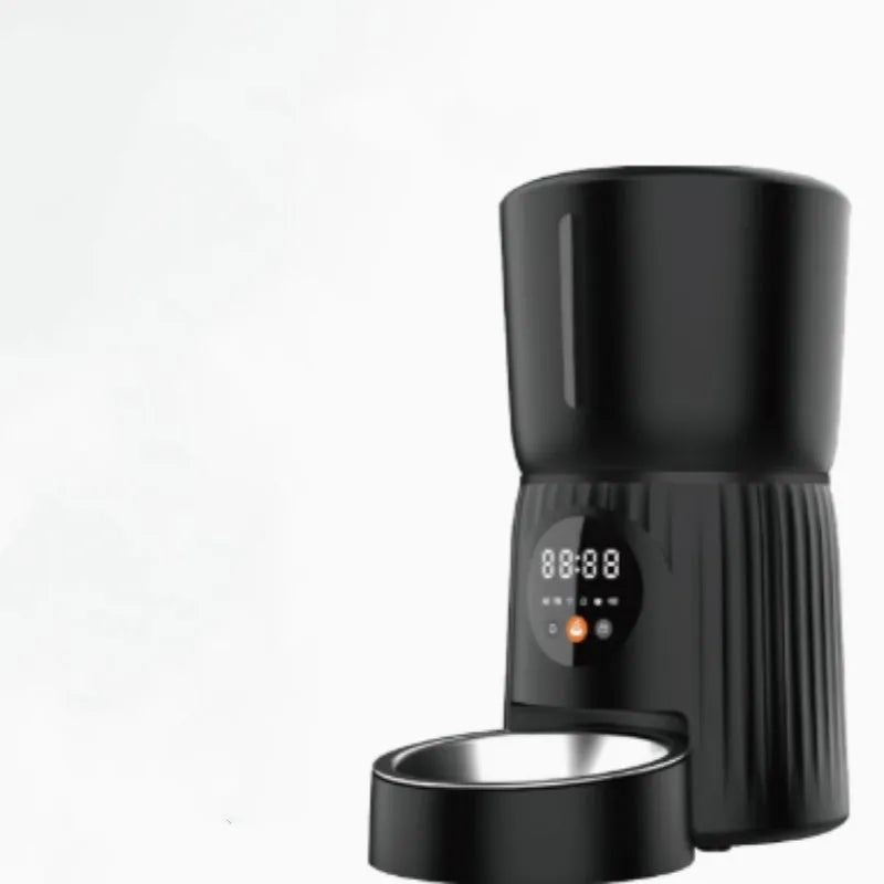 Black automatic pet feeder with digital display and food container on kitchen counter