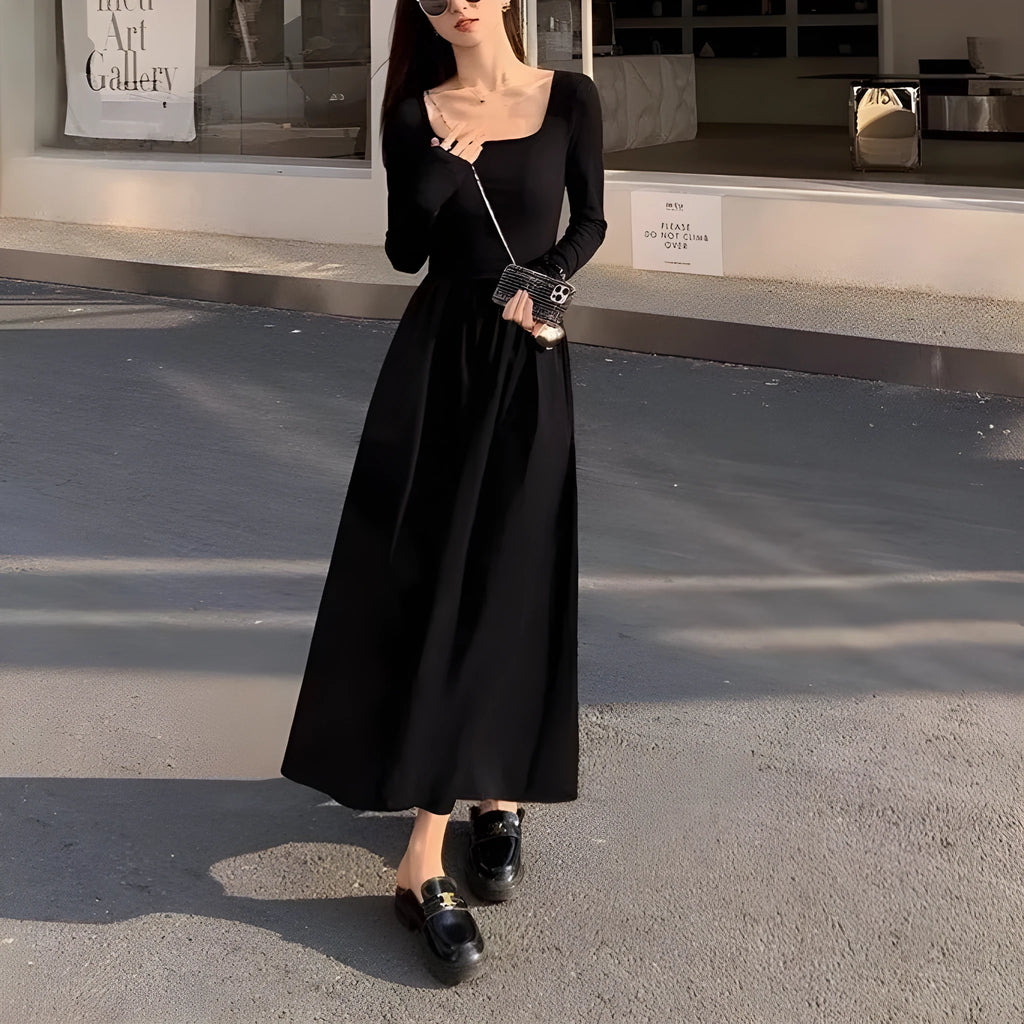 Women's black square collar knitted A-line dress with long sleeves and an elasticated waist.