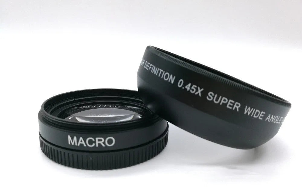 Black 52mm wide-angle macro camera lens with front and back covers on a table