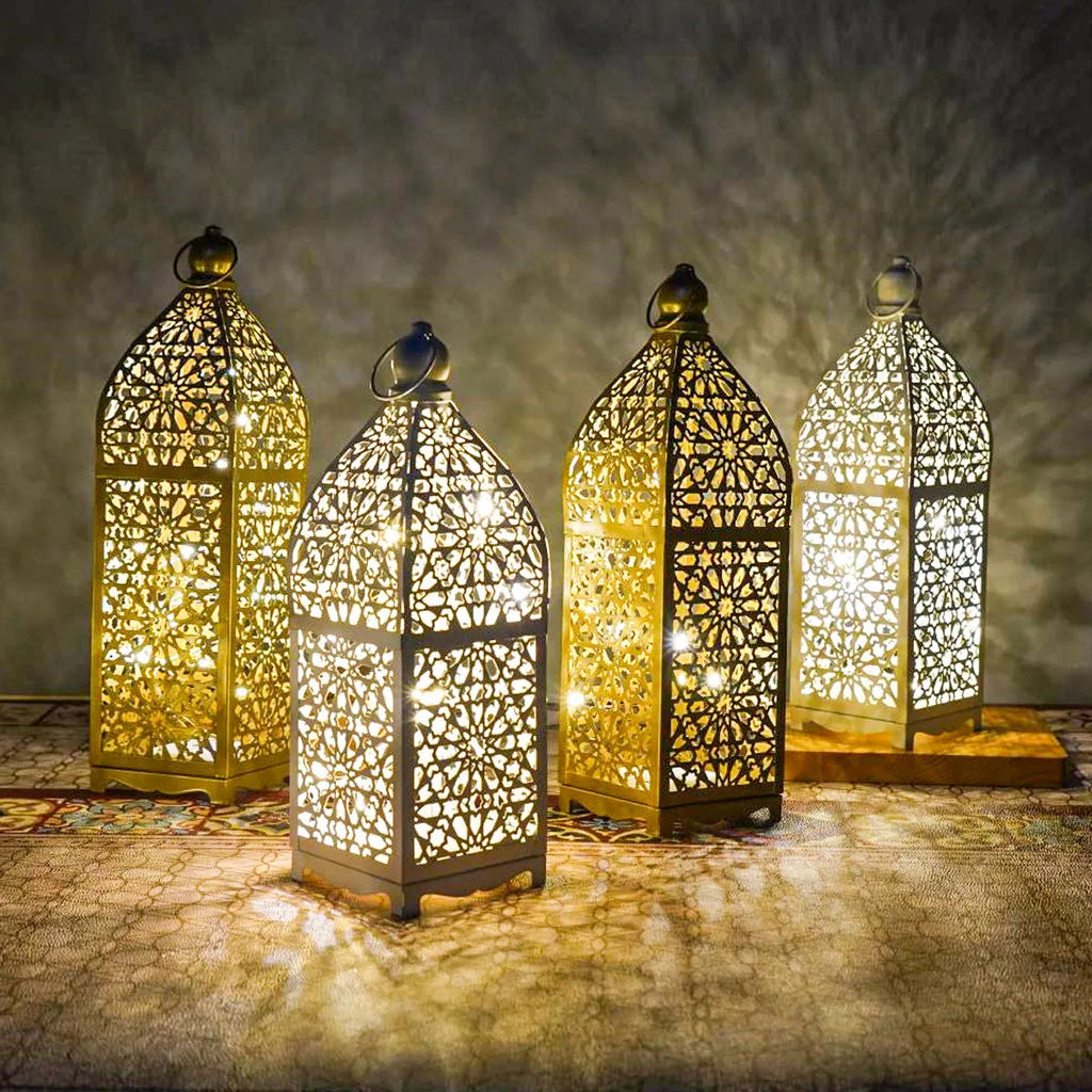 Gold L decorative iron barn lantern with hollow four-corner design on a tabletop