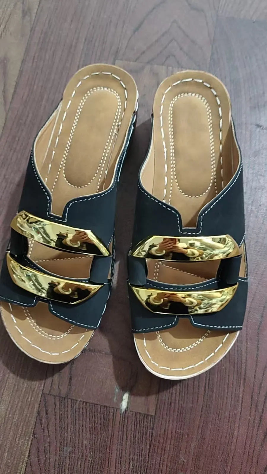 Roman style flat platform sandals in white, black, khaki, and sea blue with a metal detail and rubber sole.