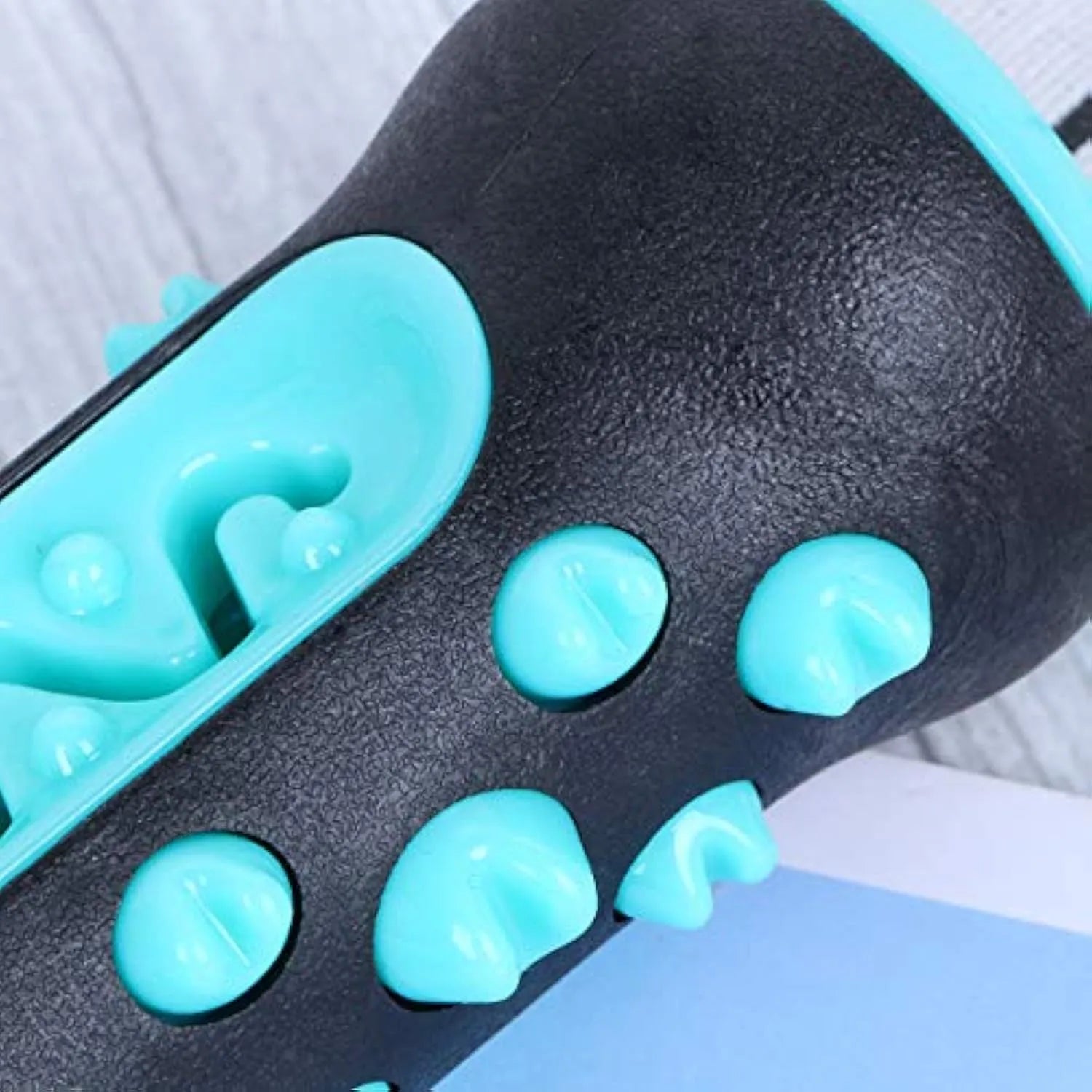 Natural rubber dog toothbrush chew toy in blue colour, showing textured surface for cleaning teeth.