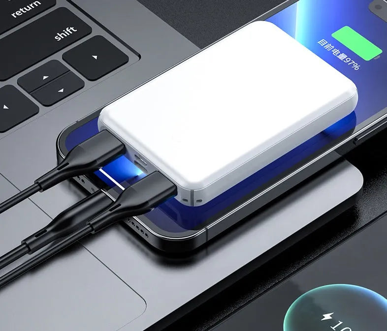 Black and white electric heating vest power bank with USB port showing compact size.
