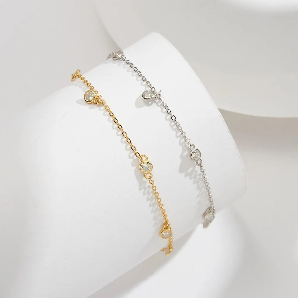 Silver women's anklet with a geometric pendant in a gold tone finish.
