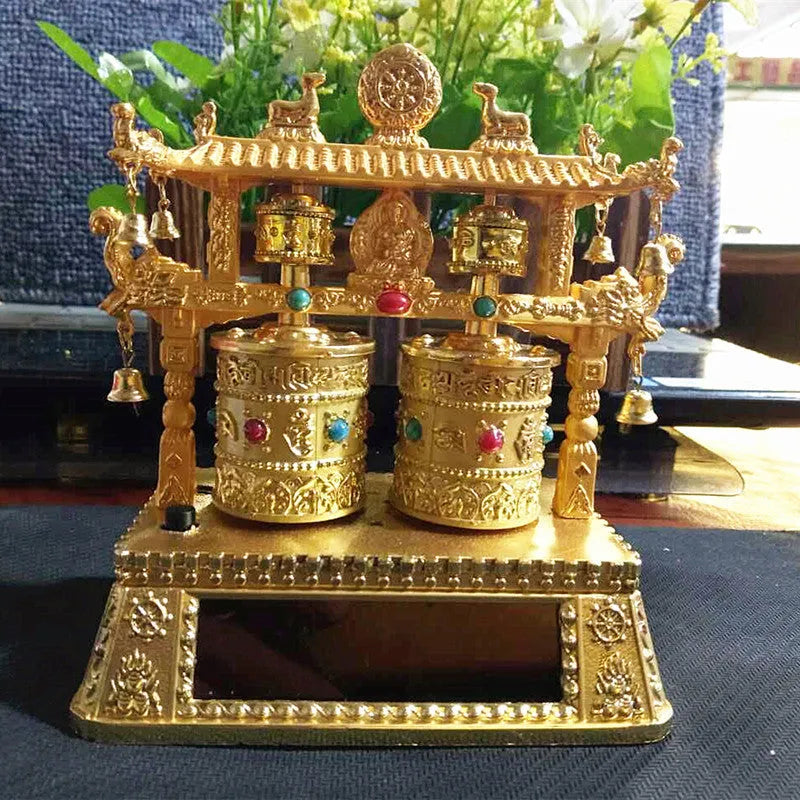 Traditional Chinese alloy prayer wheel car decoration on a dashboard