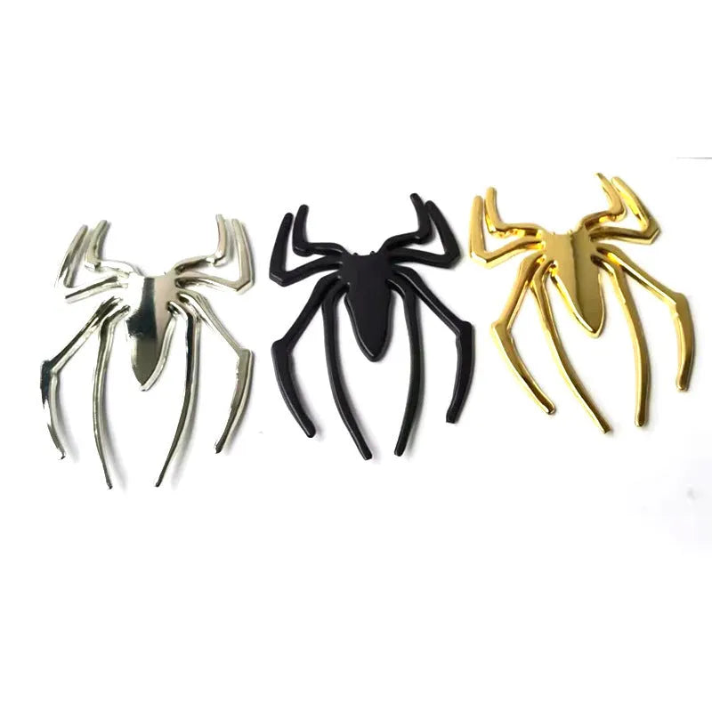 Three-dimensional metal spider bumper sticker in zinc alloy, showing gold, silver, black, and red colour options.